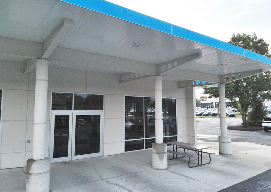 After photo of car dealership in Frederick, MD following soft-wash by a drone - bright, white and clean.